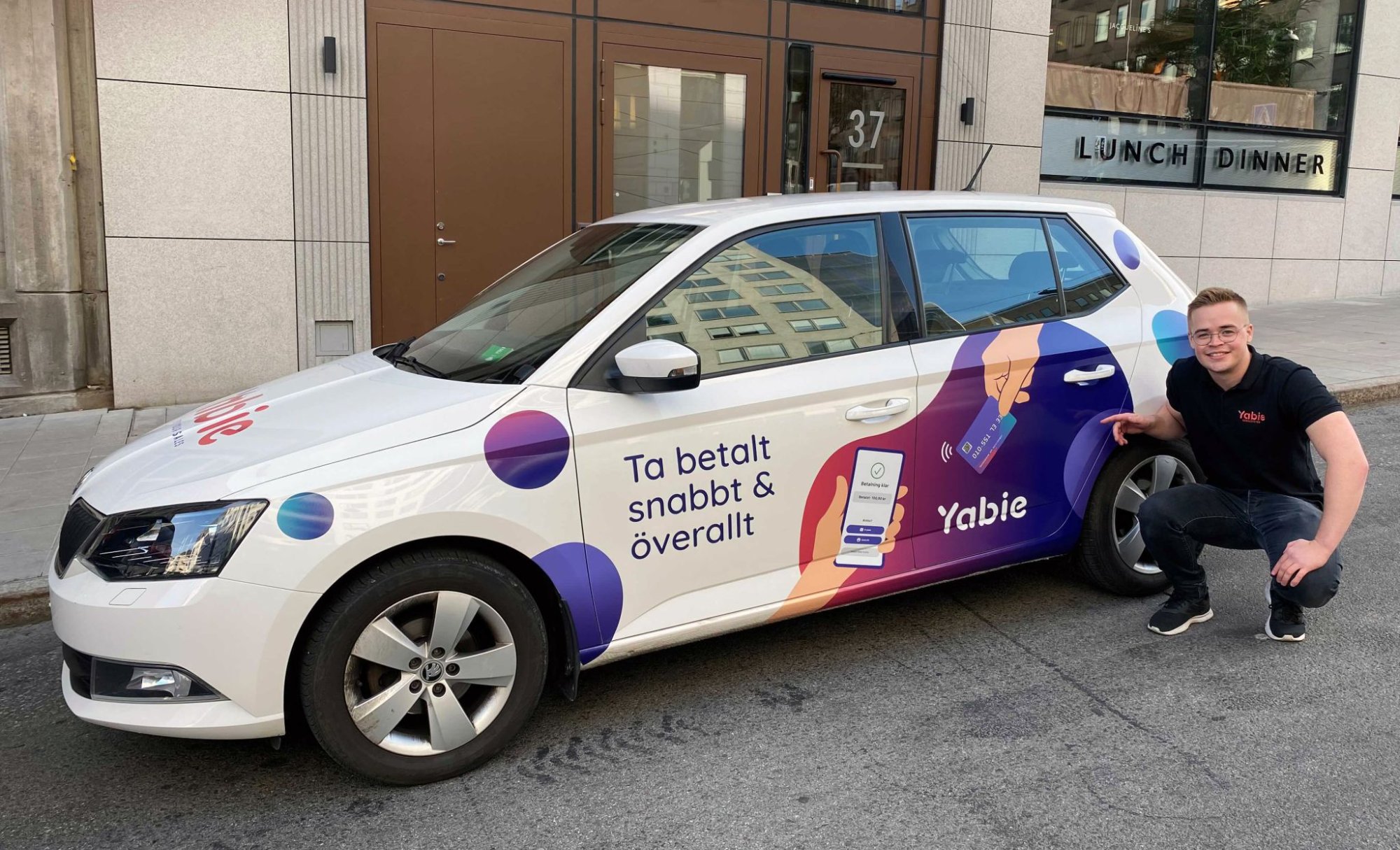 Max next to a Yabie branded car